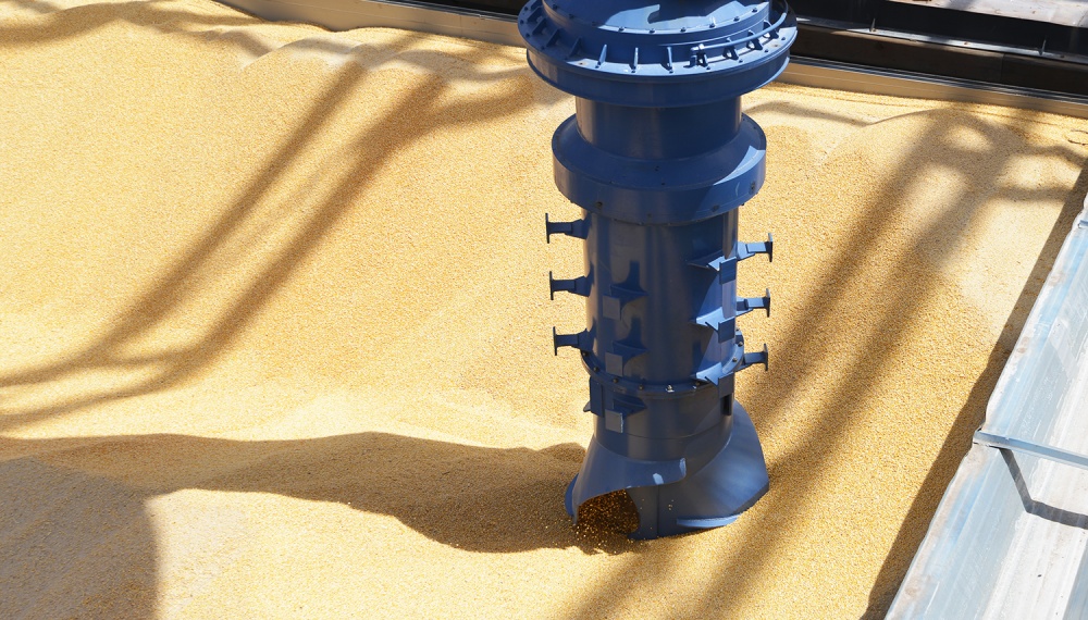 Closeup of Inlet feeder and vertical screw conveyor unloading grain from barge