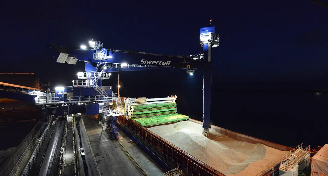 Blue Siwertell Ship unloader in operation at night